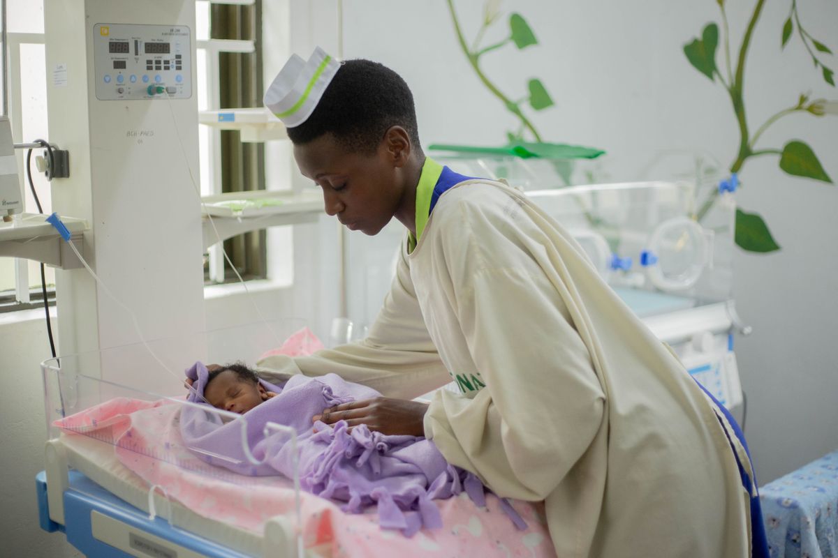 Nurse watching over a newborn in a maternity ward